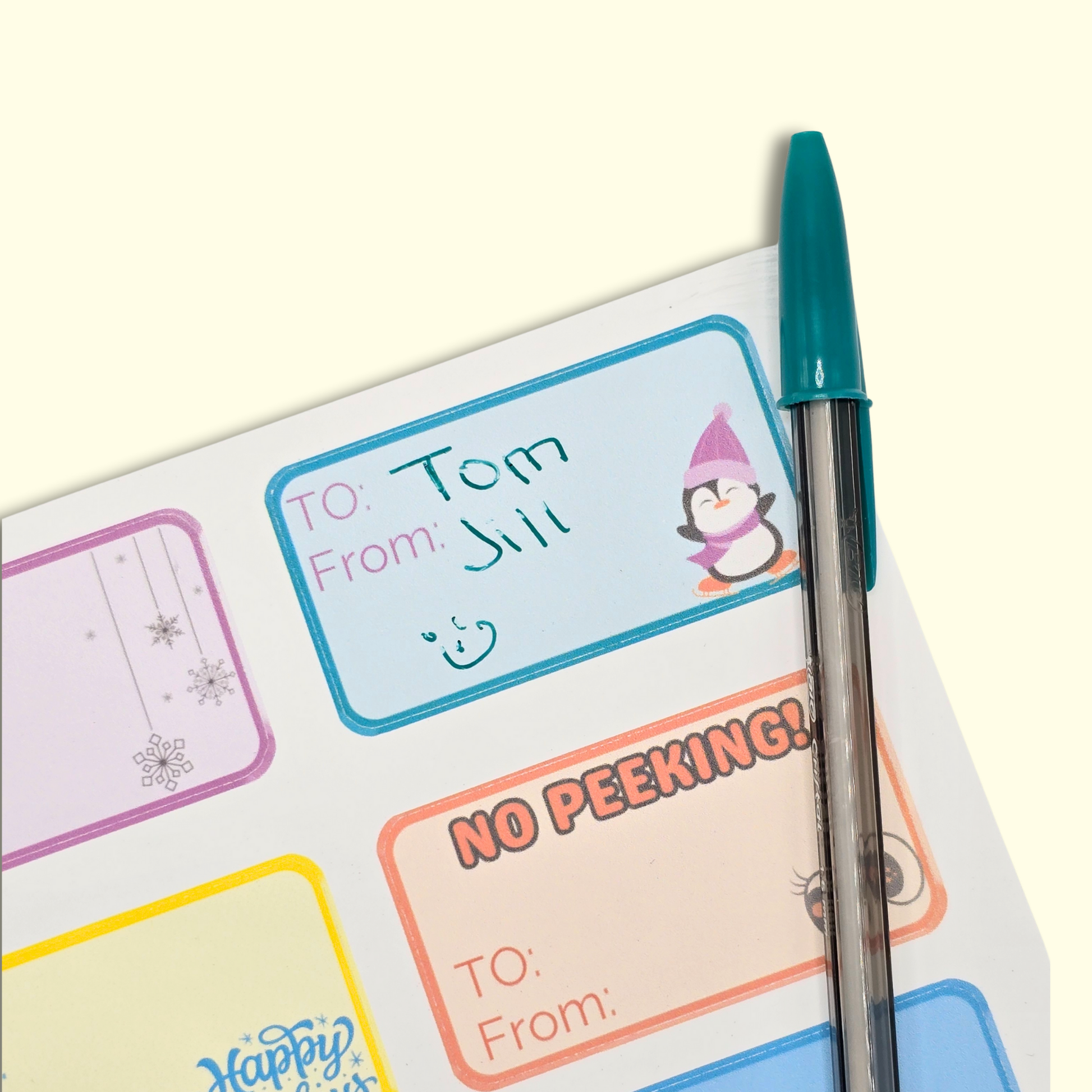 Set of colorful labels with text and a pen on a white background